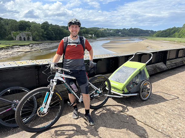 Andrew Middleton cycling beside the river